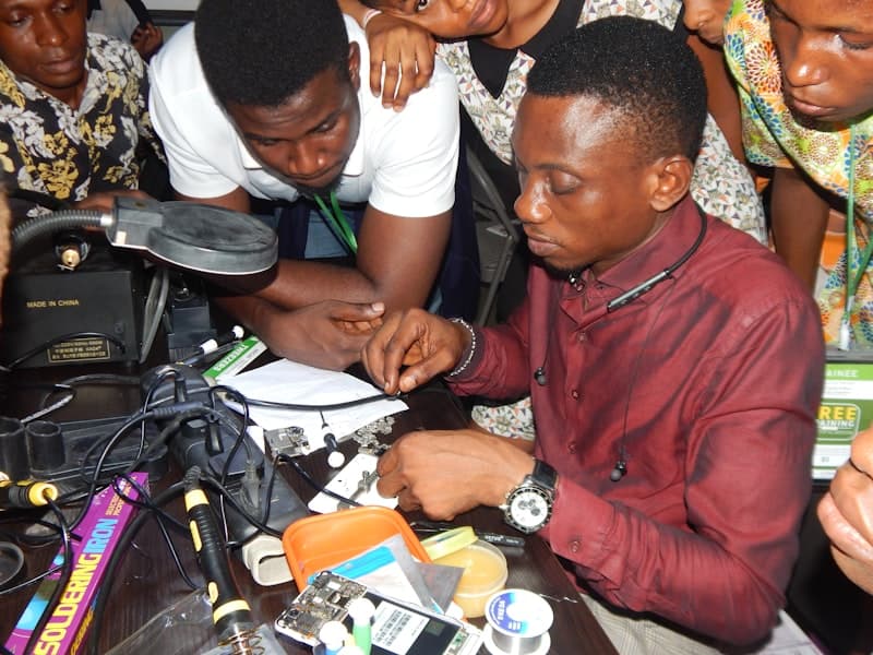 Students analyzing hardware component together