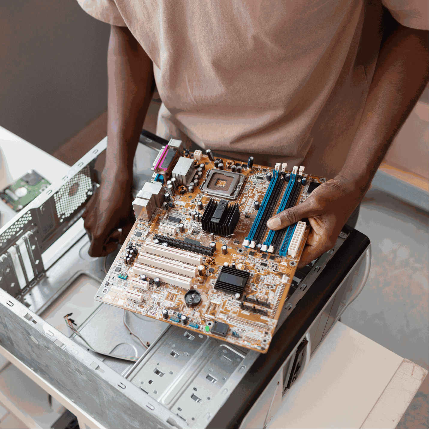 Person in black gloves working on electronic circuit board